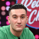 Reality star Joey Sasso smirks at the camera in a green shirt